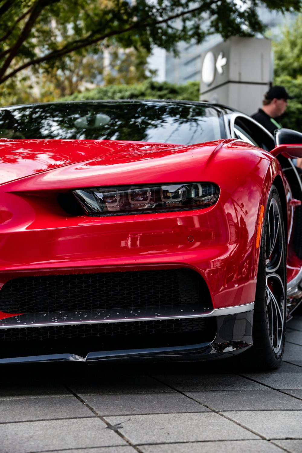 a red sports car parked on the side of the road