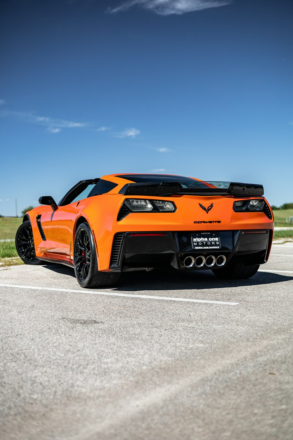 an orange sports car parked in a parking lot