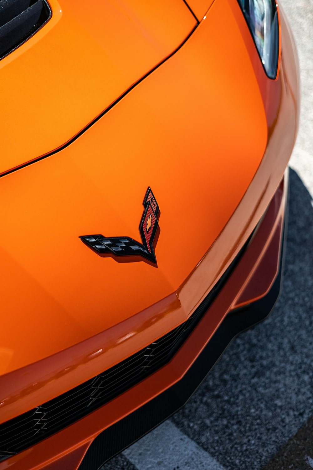 a close up of the hood of an orange sports car