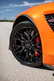 a close up of a sports car on a road