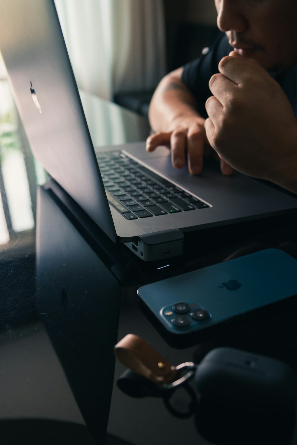 a man sitting in front of a laptop computer