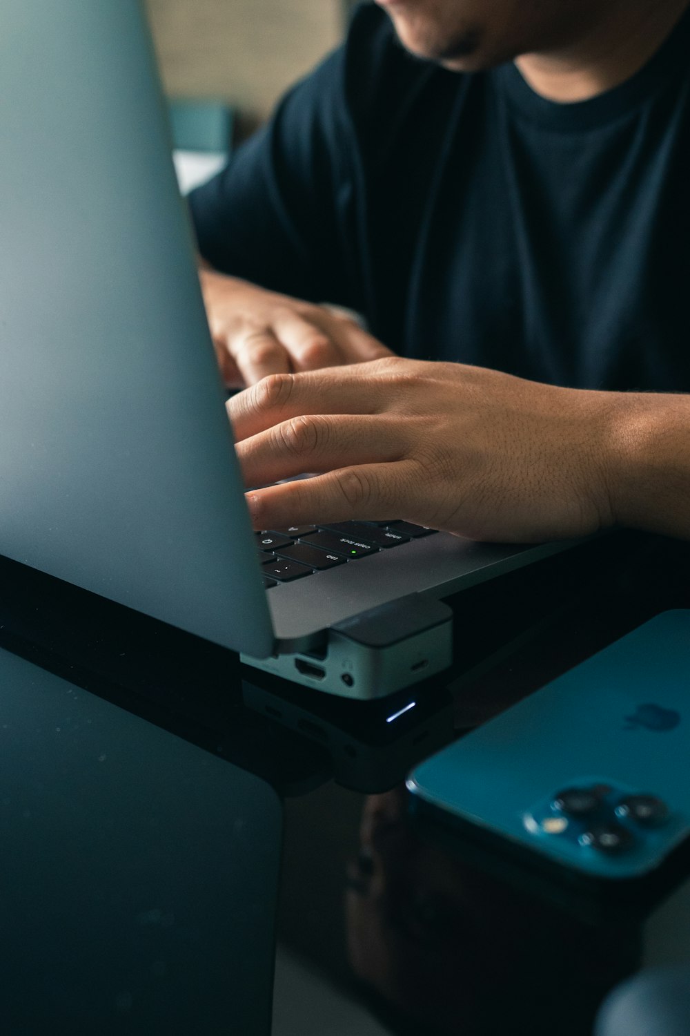 a man sitting at a table using a laptop computer