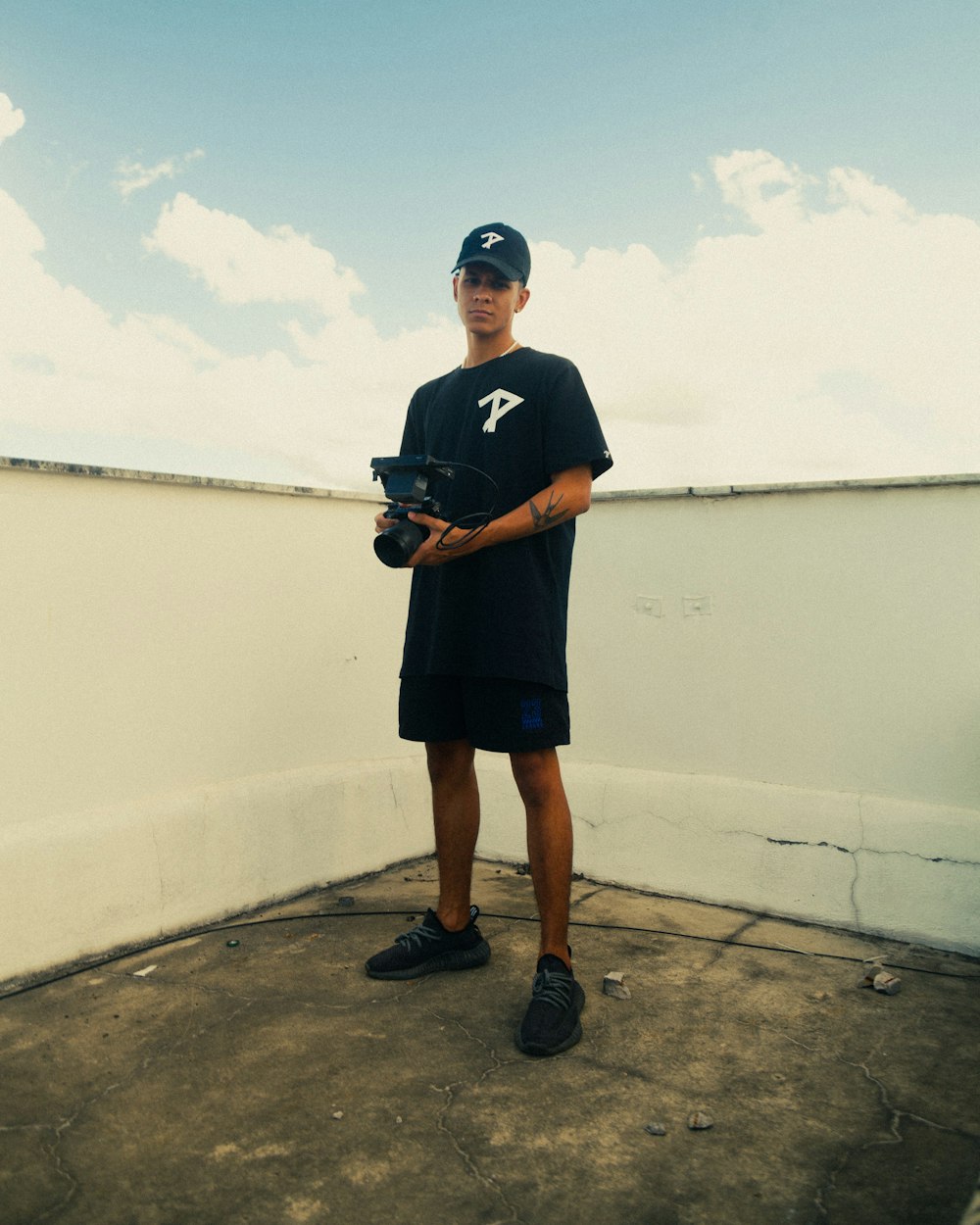 a man holding a baseball glove on top of a roof