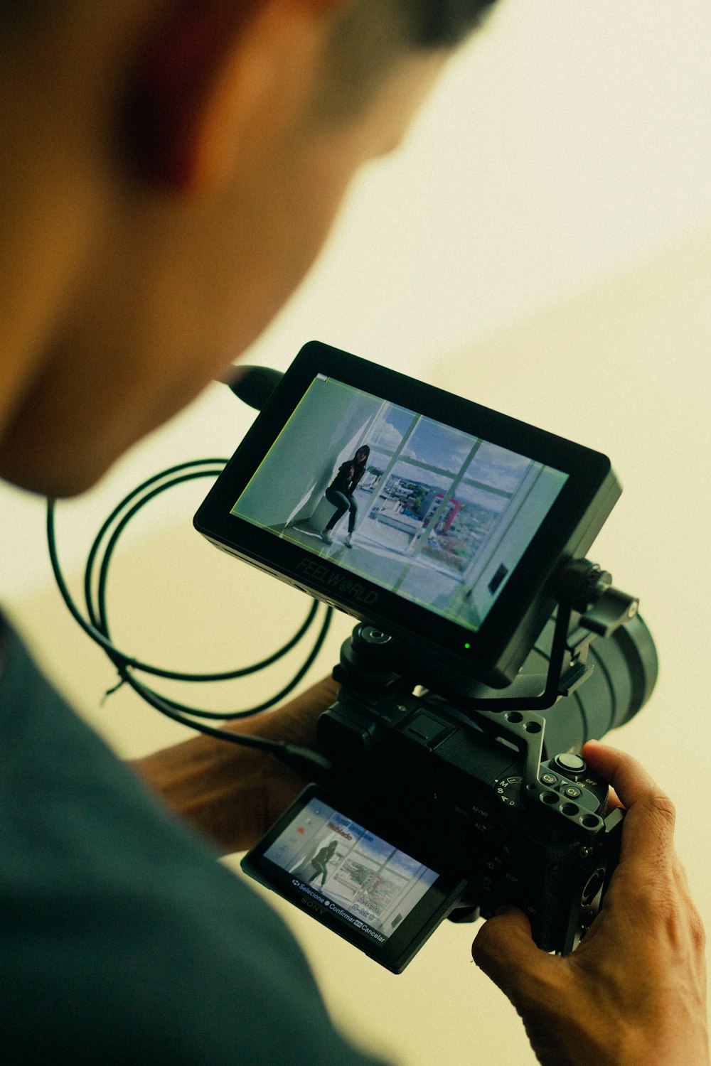 a man holding a camera and recording a video