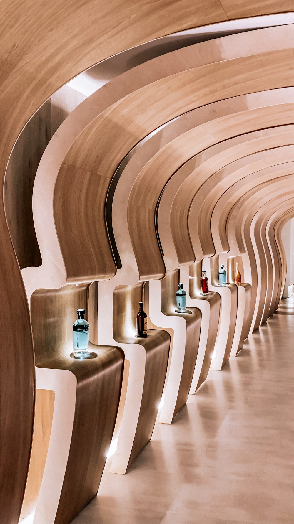 a row of wooden benches lined up against a wall