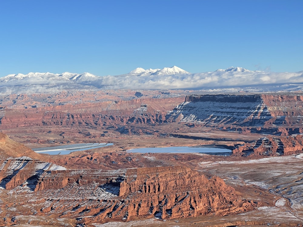 a scenic view of a mountain range with a lake in the foreground