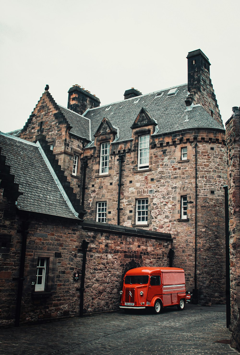 a red truck parked in front of a tall brick building