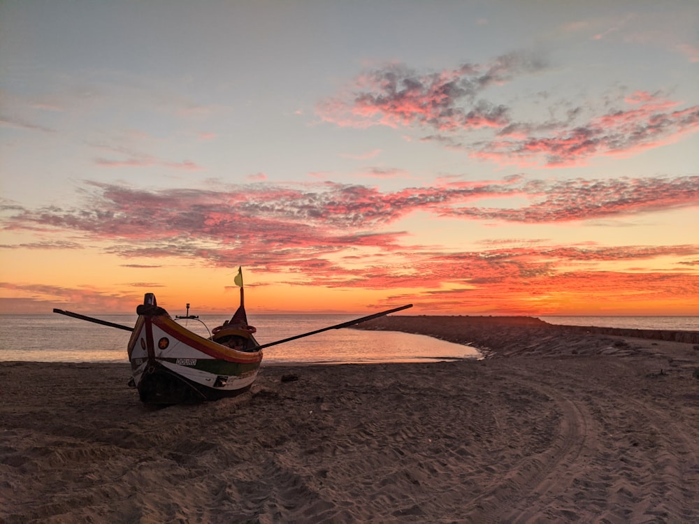 Un bateau assis au sommet d’une plage de sable