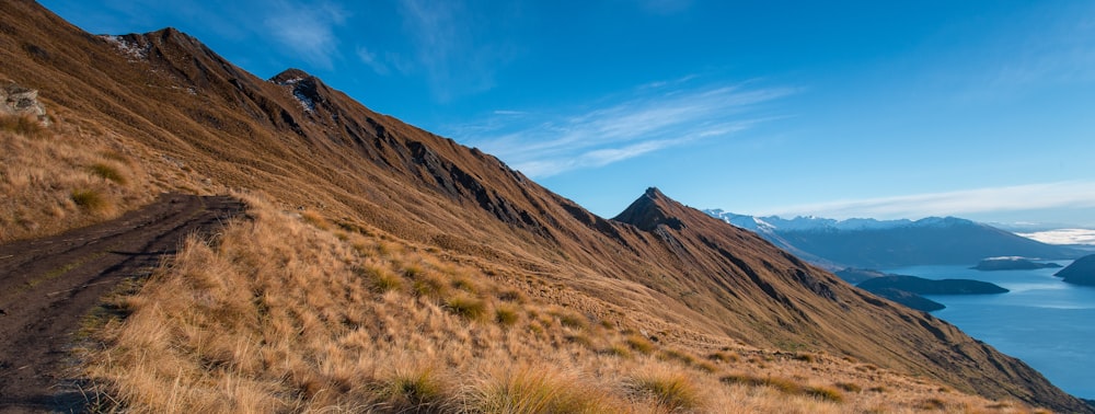 a view of a mountain with a body of water in the distance