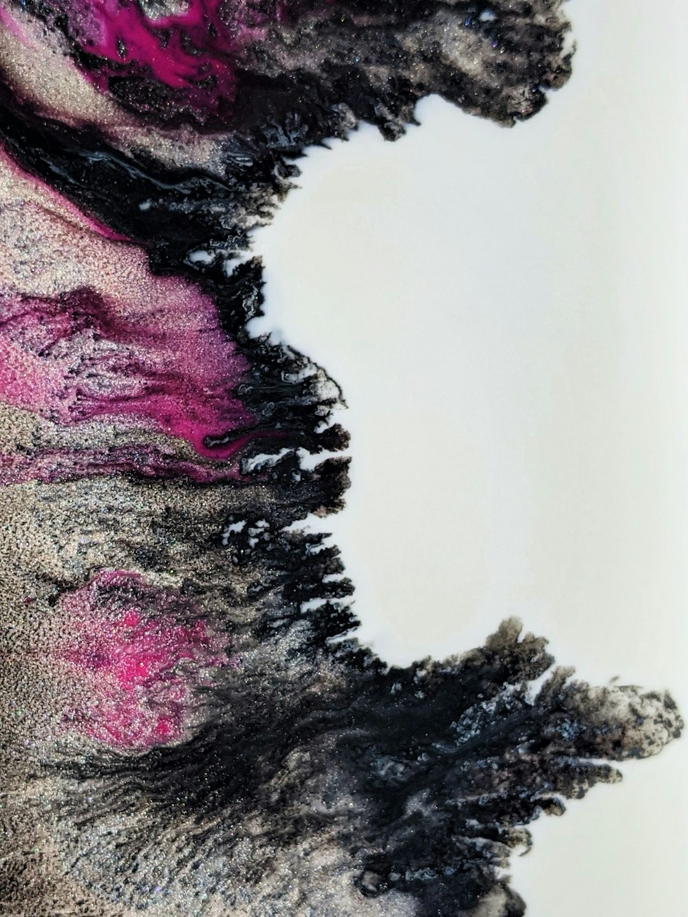 a black and pink piece of art on a white surface