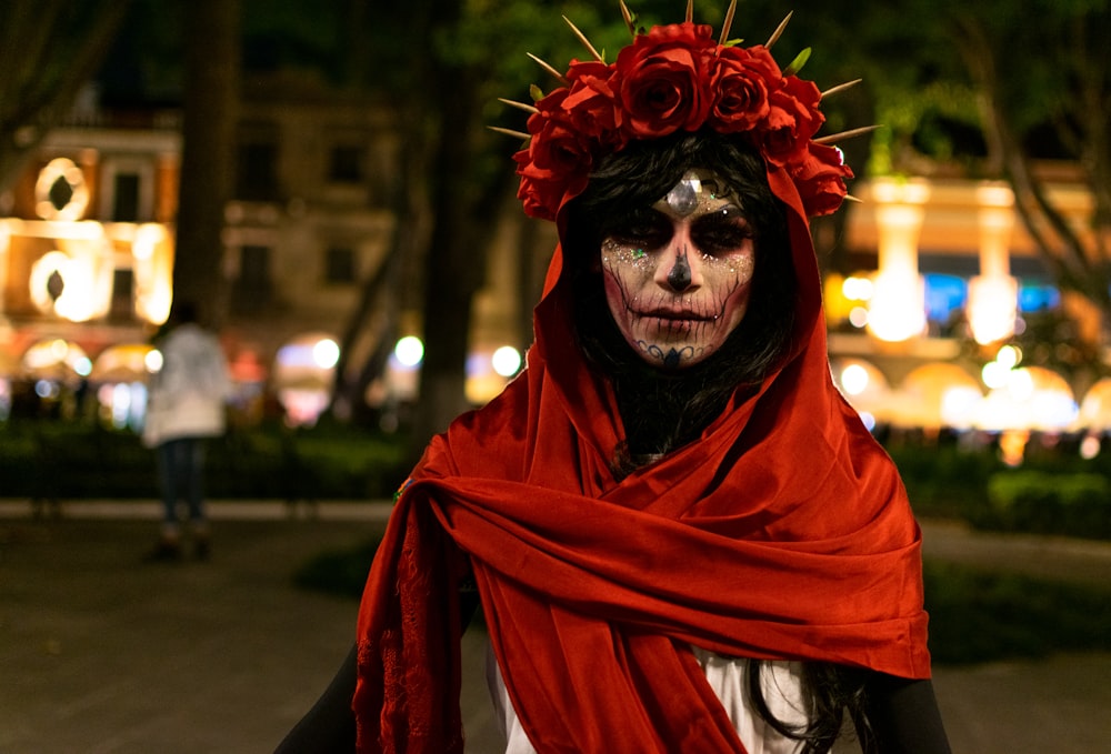 a woman with makeup and flowers on her head