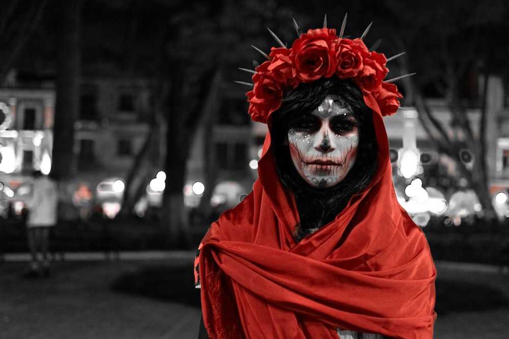 a woman with makeup and a red scarf around her neck