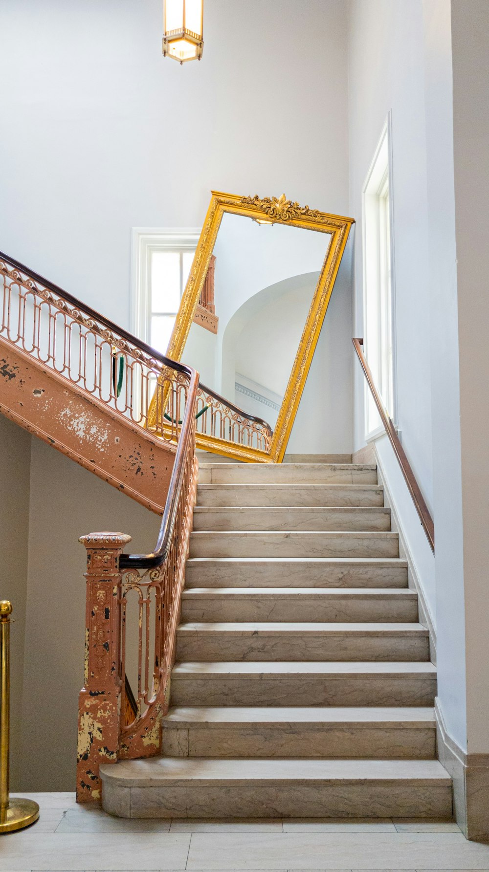 a staircase with a mirror on the wall