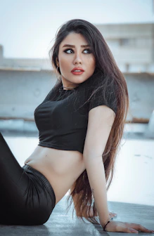 a woman in a black top posing for a picture