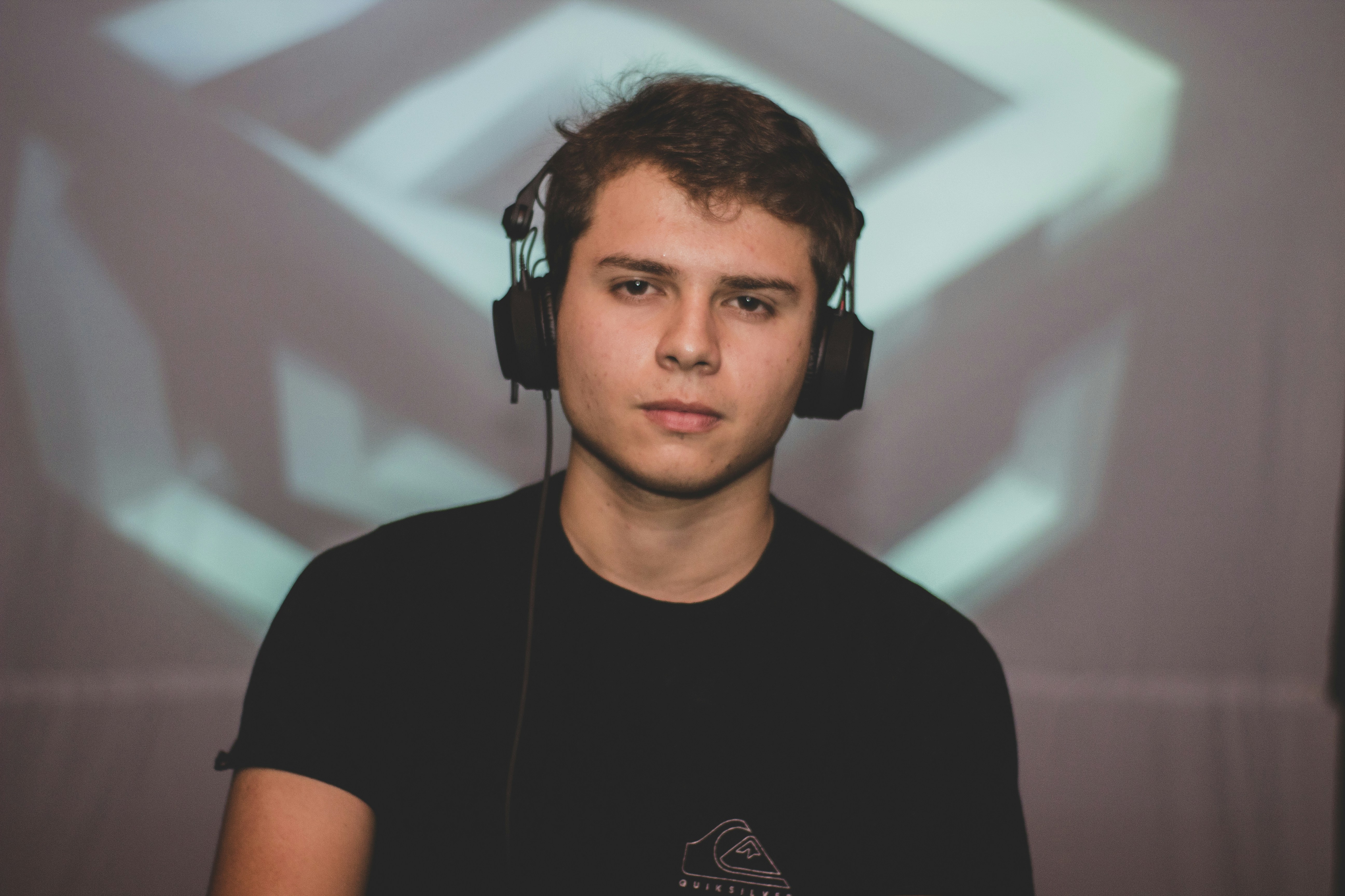 a young man wearing headphones in front of a projection