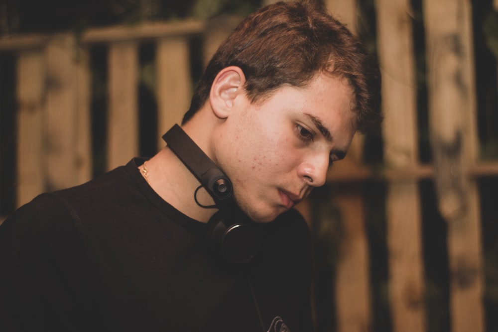 a young man wearing a pair of headphones