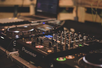 a dj's turntable with a laptop in the background