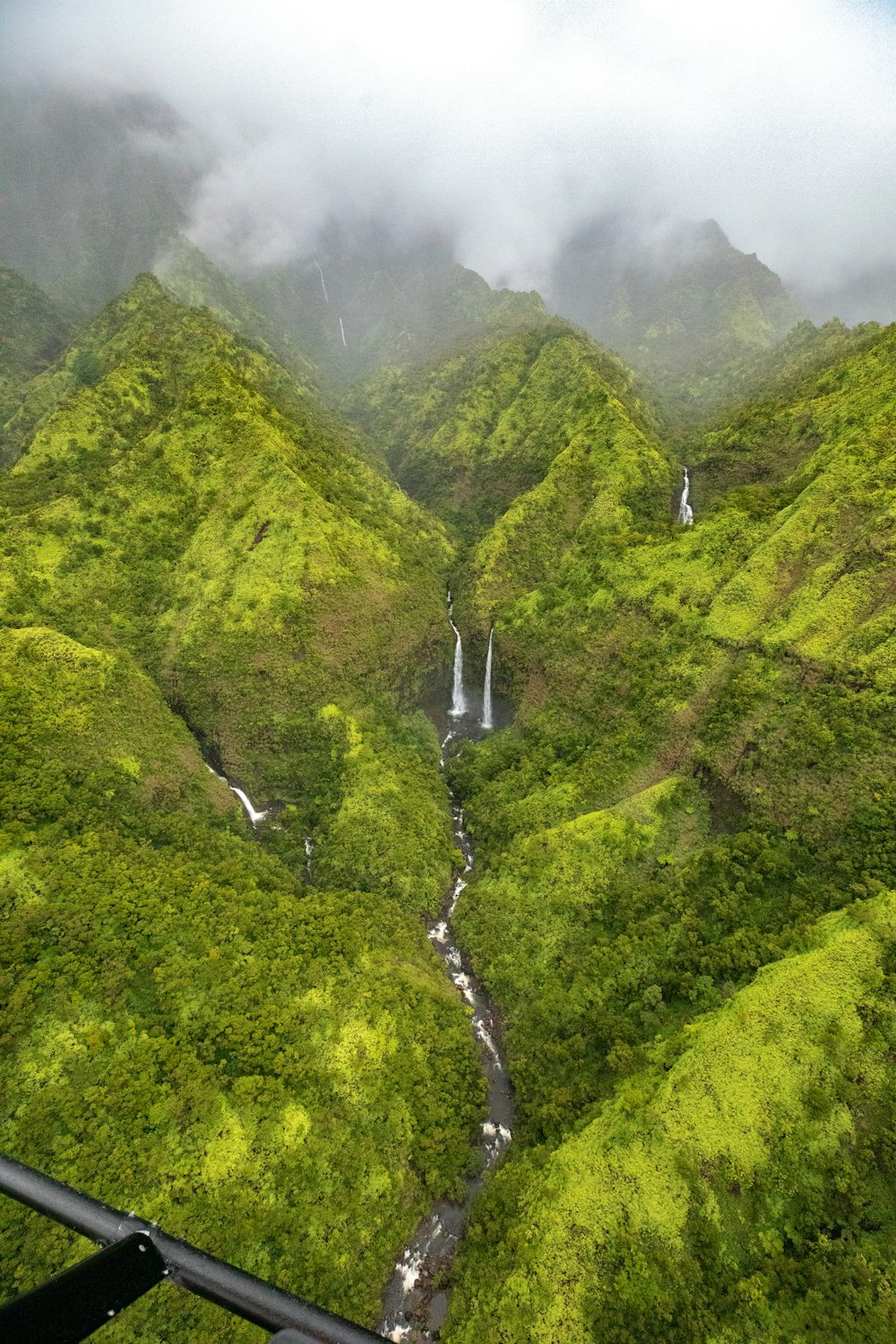 a scenic view of a waterfall in the mountains