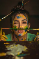 a woman with her face painted yellow and blue