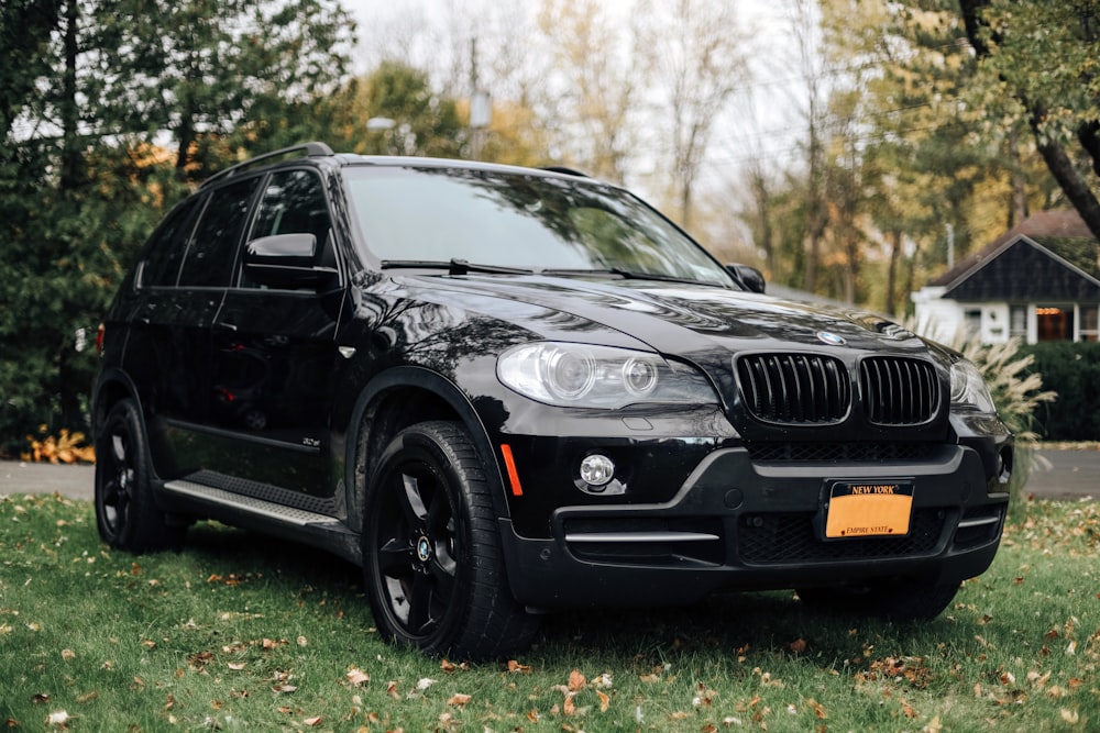 a black bmw x5 parked on the side of the road