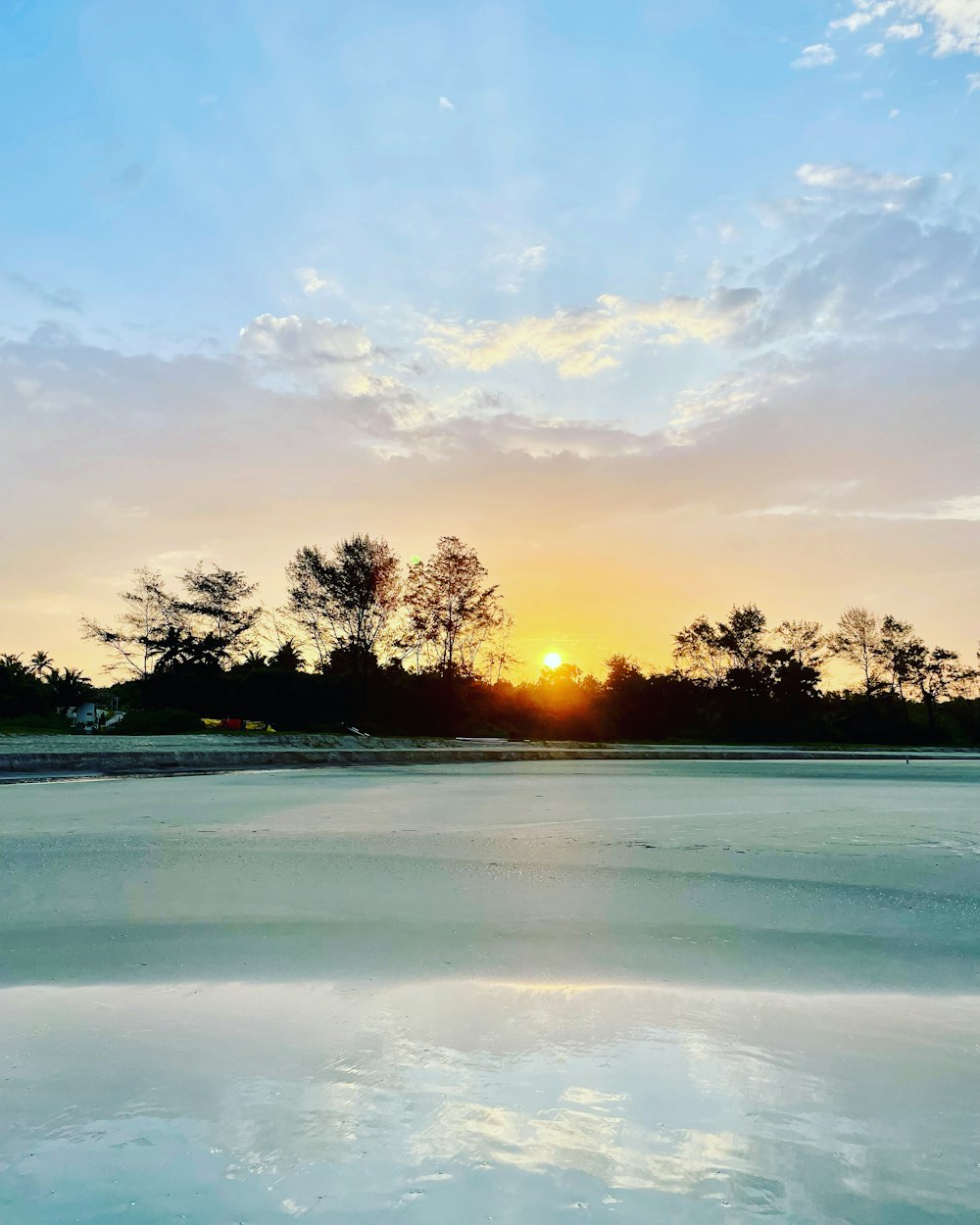 the sun is setting over a body of water