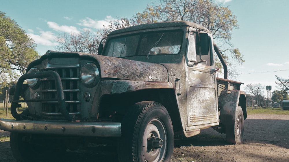 an old truck parked on the side of the road