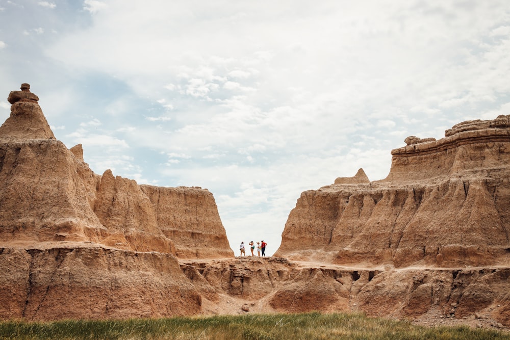 a group of people standing on top of a dirt hill