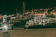 Evening view of a marina lit up with warm lights reflecting on the calm sea.
