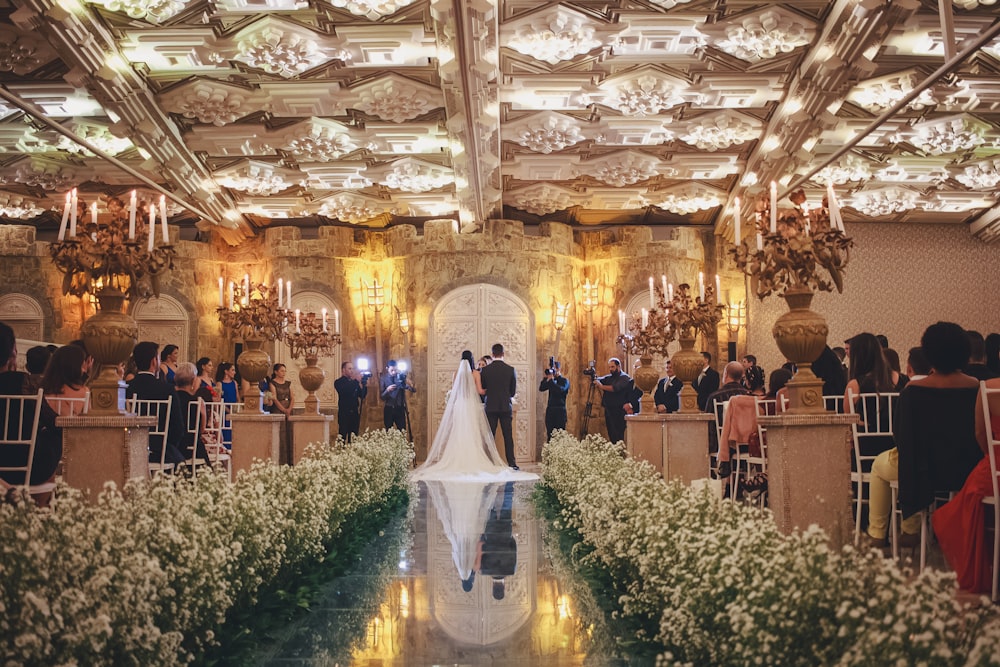 a bride and groom standing at the end of a wedding ceremony