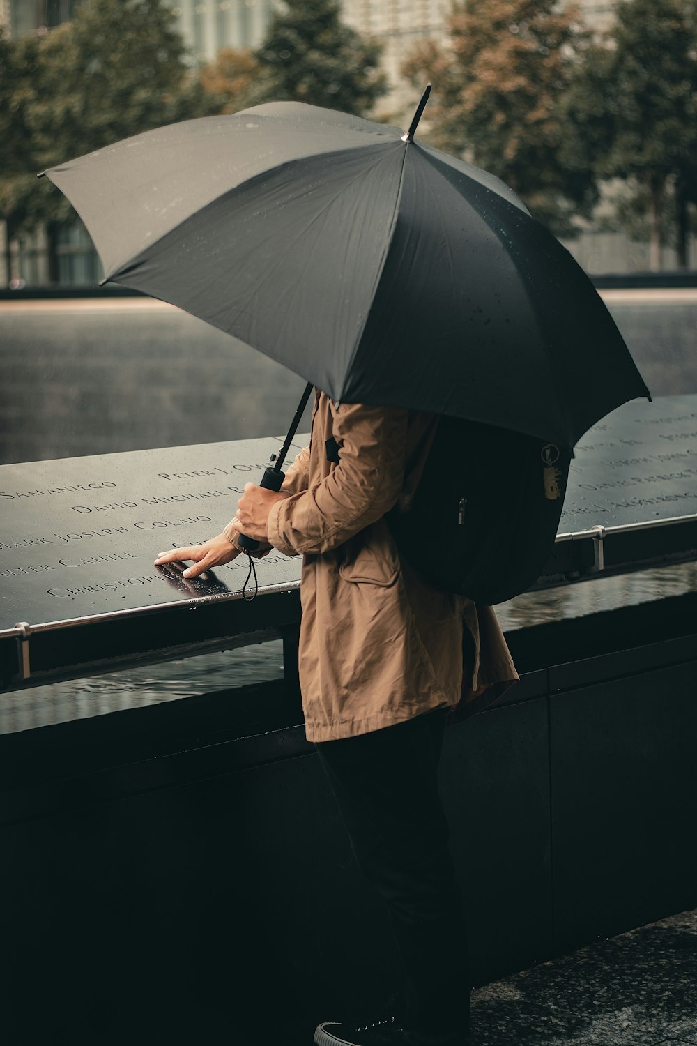 a person with a backpack and an umbrella