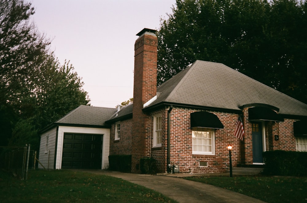 a brick house with an american flag on the front