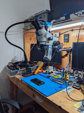 a workbench with a computer and tools on it