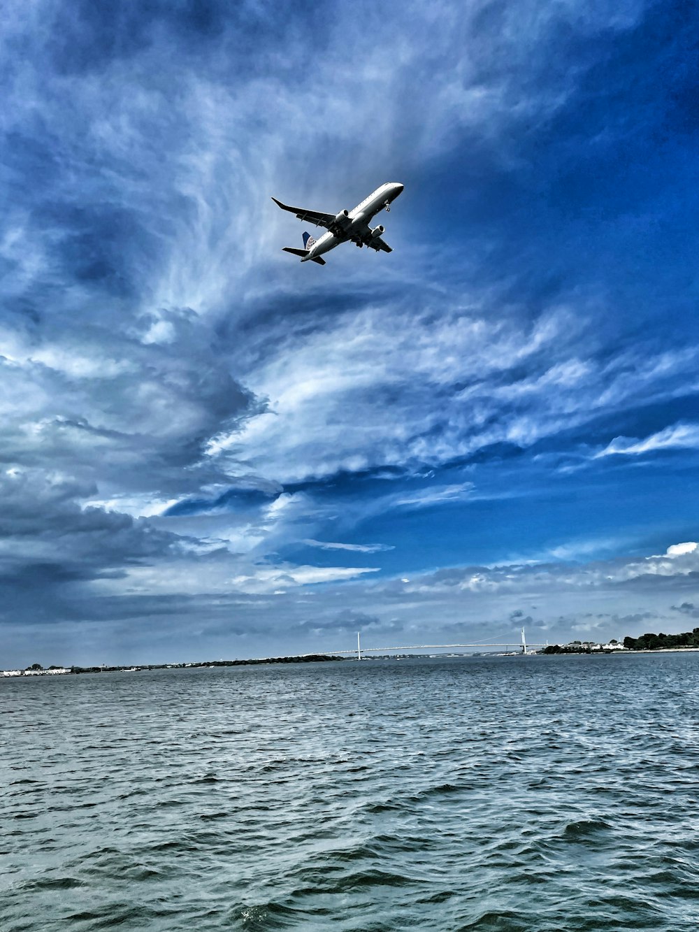 an airplane flying over a body of water