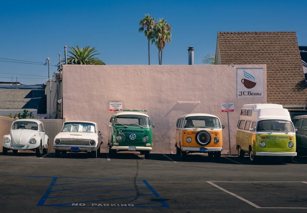 a row of vw buses parked in front of a building