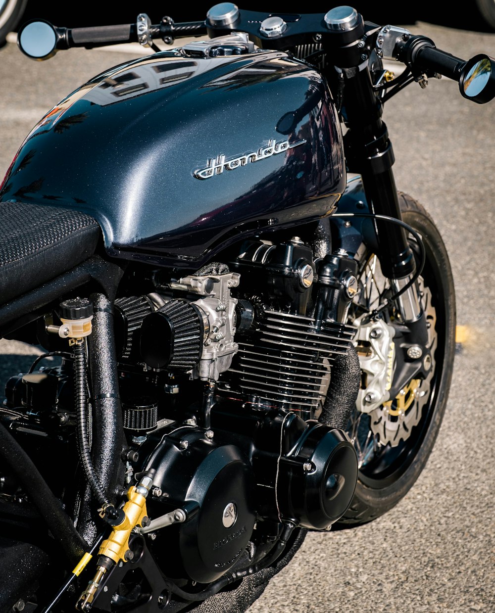 a close up of a motorcycle parked in a parking lot