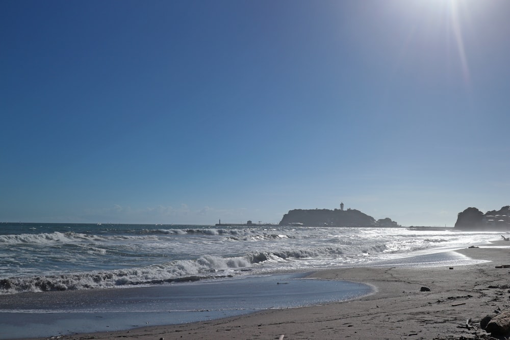 a sunny day at the beach with waves coming in