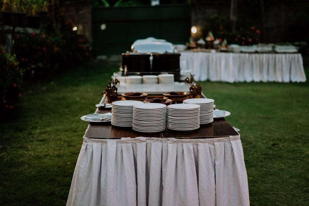 a table set up with plates and plates on it