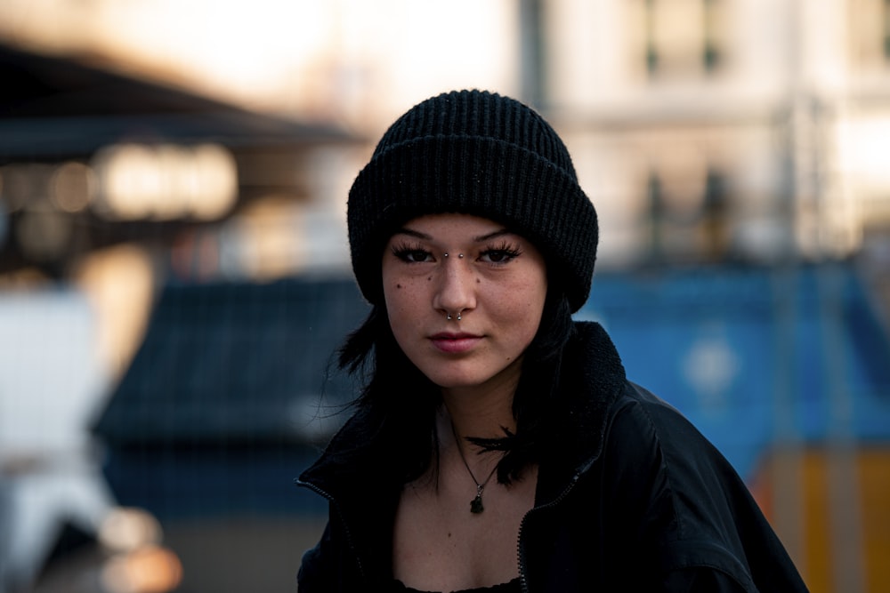 a woman wearing a black hat and a black jacket