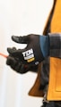a person wearing a yellow jacket and black gloves