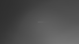A minimalistic and abstract image featuring a small, thin horizontal line centered against a gradient background that transitions from dark gray to light gray.