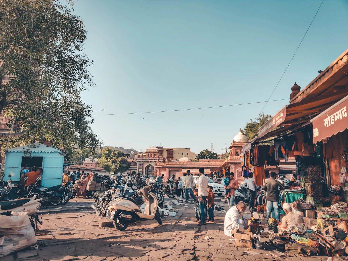 Delivery motorcycles parked along an Indian street