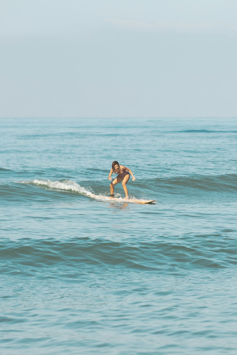 a person riding a surf board on a body of water