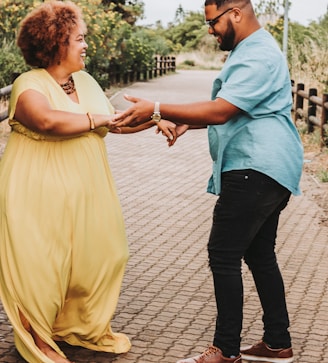 a woman in a yellow dress and a man in a blue shirt