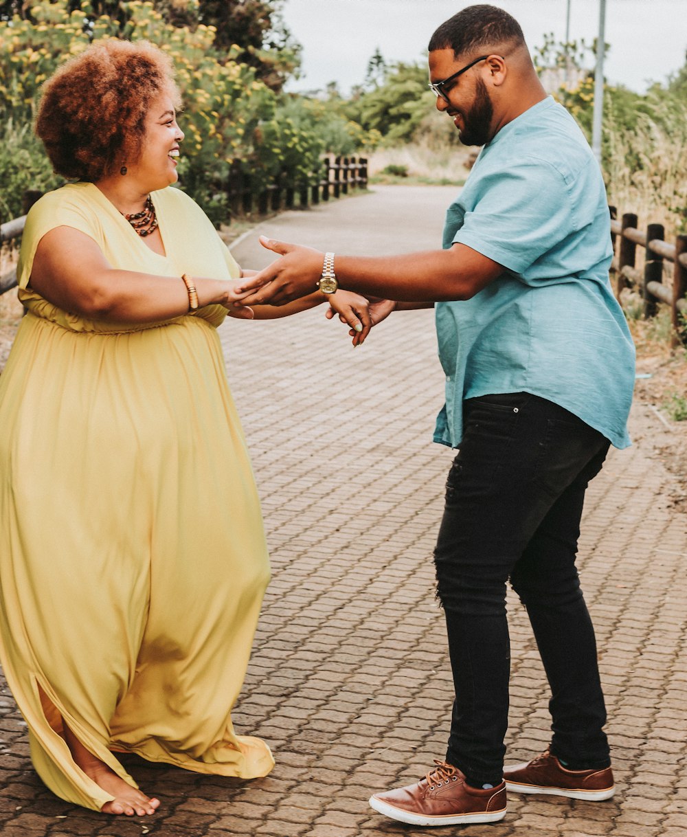 a woman in a yellow dress and a man in a blue shirt