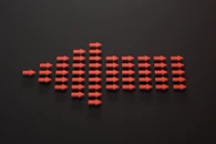 a group of red arrows on a black surface
