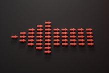 a group of red arrows on a black surface