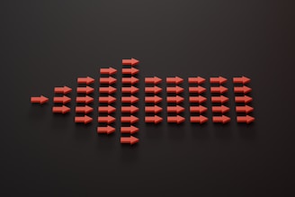 a group of red arrows on a black surface