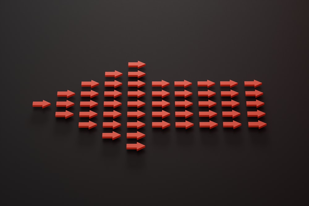 a group of red arrows on a black surface