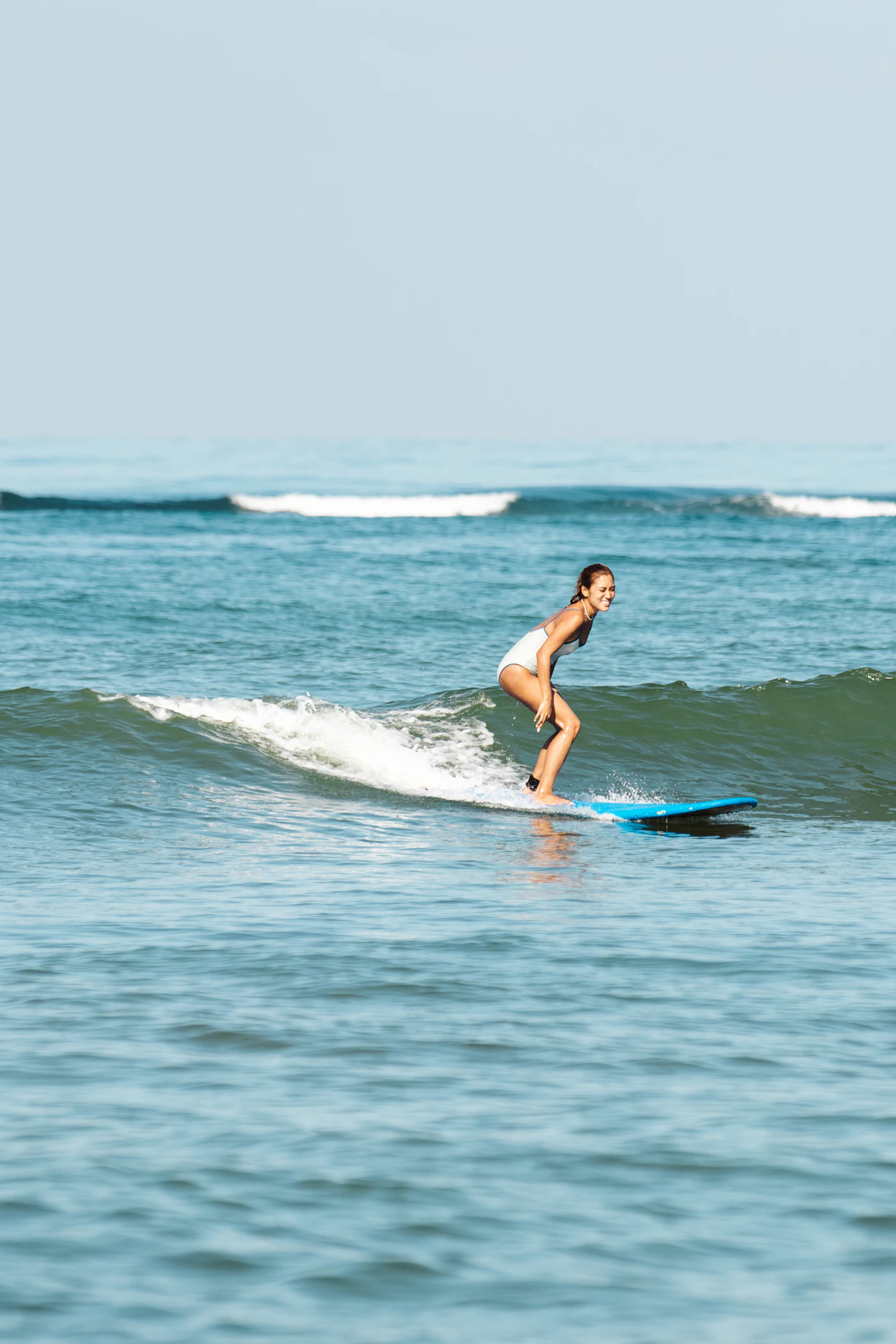 A woman riding a wave on her surfboard