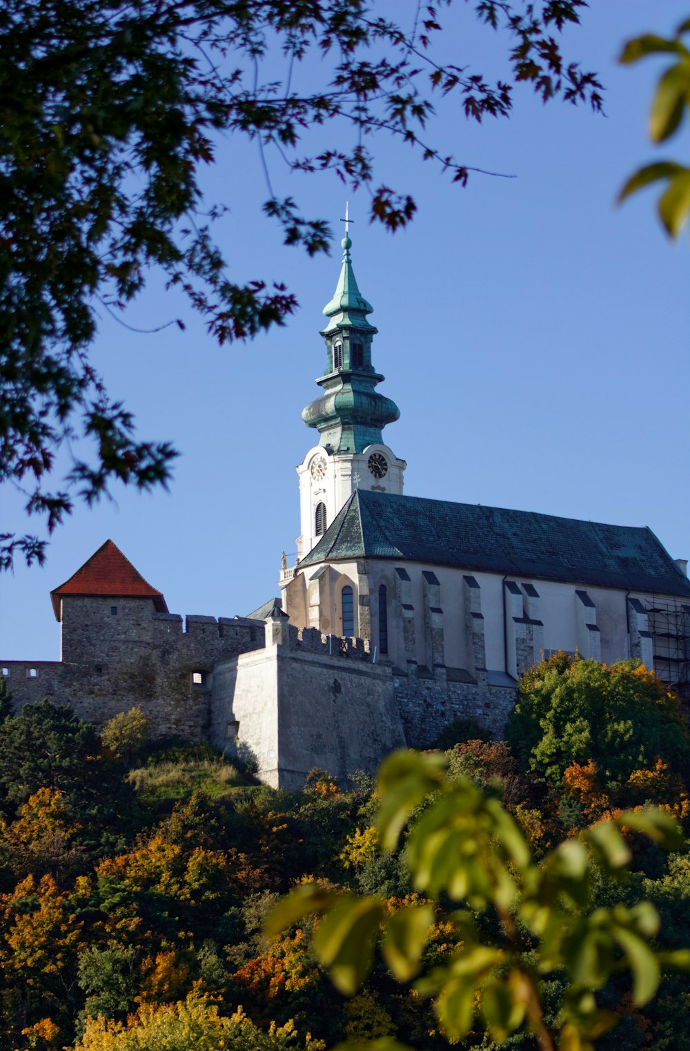 a large building with a steeple on top of a hill